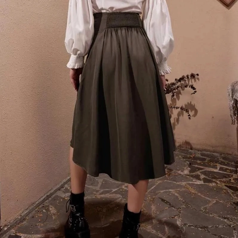 Model from behind wearing dark steampunk pirate skirt in midi length, showcasing back silhouette and shirred elastic waist detail