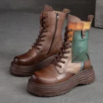 Women's steampunk platform combat boots with genuine leather color-block upper and thick ridged sole, front three-quarter view showcasing metal side zipper and lace eyelet details