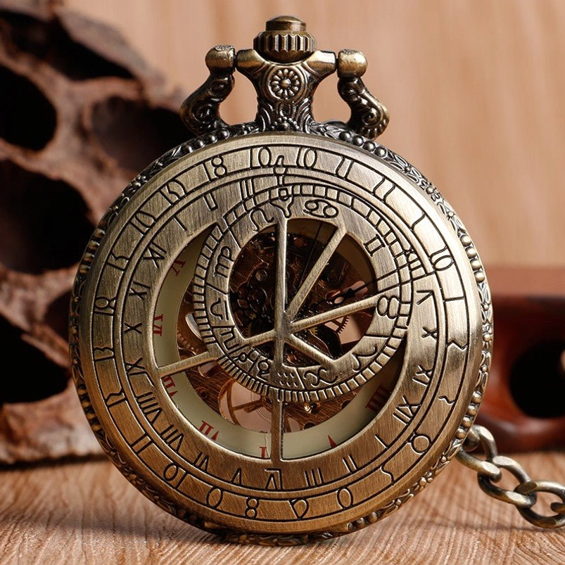 Steampunk pocket watch with hollowed astrolabe dial showing telluric lines and hermetic symbols, bronze finish with floral carved details and transparent viewing panel