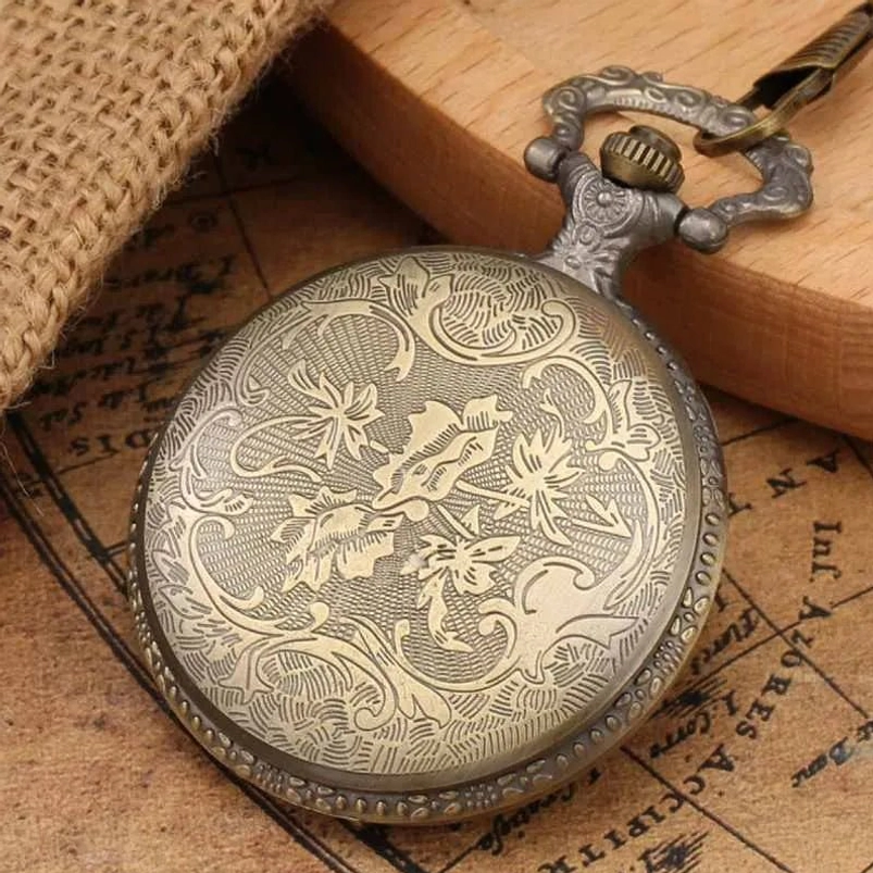 Steampunk pocket watch back cover case with intricate floral scroll engraving and ornate hardware, bronze metal with detailed botanical pattern on burlap and map backdrop