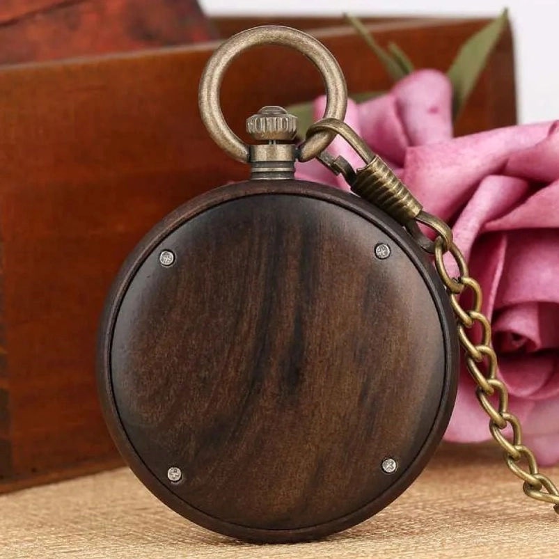 Rear side of wooden steampunk pocket watch displaying solid dark wood back cover with four brass fixing screws and bronze hanging loop, authentic industrial steampunk design
