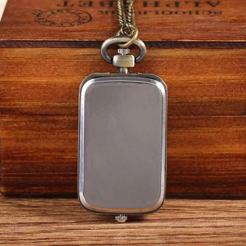 Back side of rectangular steampunk pocket watch showing matte silver backplate and antique bronze frame with winding crown