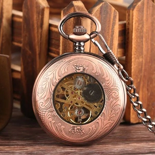 Back view of bronze steampunk pocket watch revealing full skeleton movement through hollow case cover with intricate floral engraving