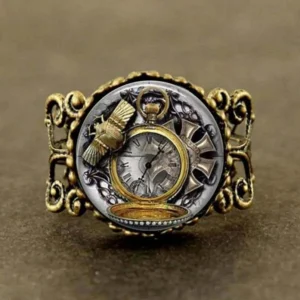 Steampunk vintage pocket watch ring with antiqued bronze hollow carved scroll band, featuring pocket watch, beetle, and cross motifs in dual gold and silver tones with glass accents