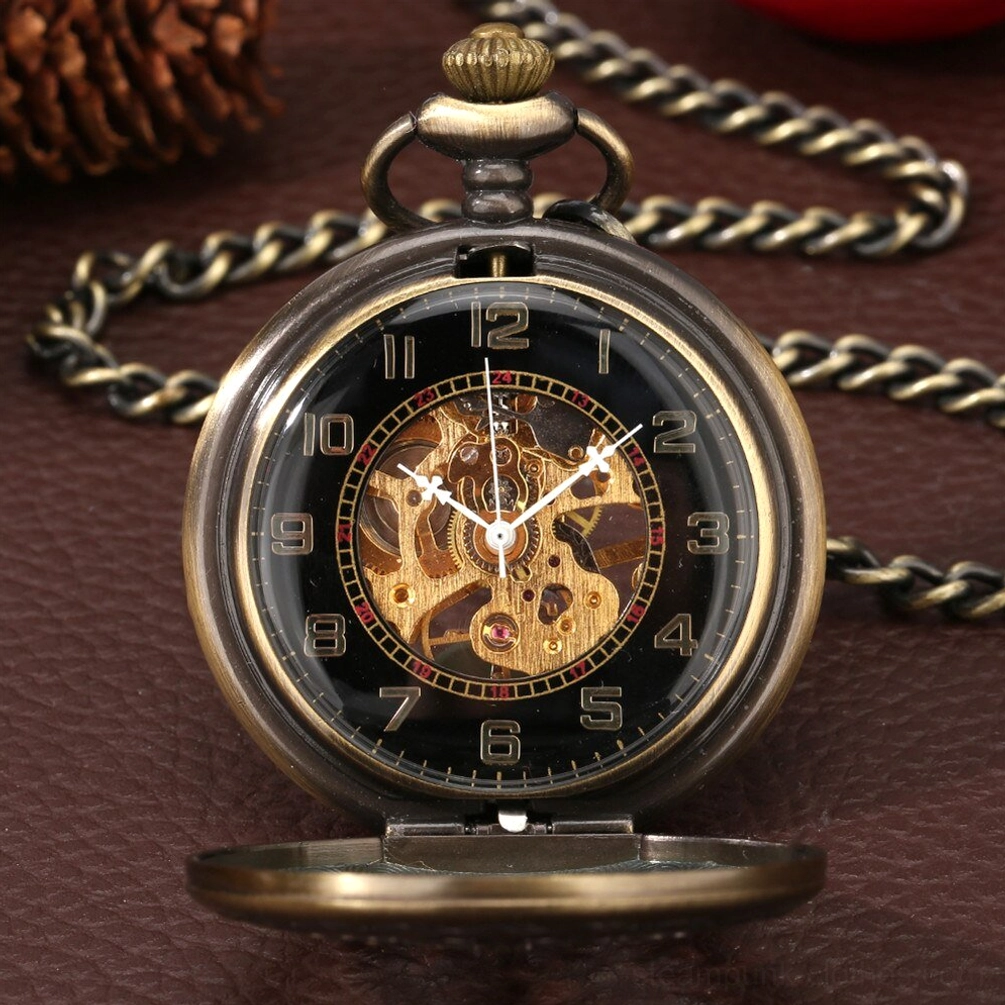 Black dial steampunk pocket watch with golden exposed gears and bronze frame on leather surface