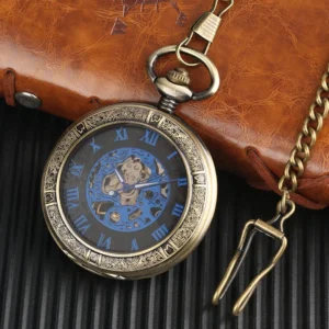 Blue steampunk pocket watch with exposed mechanical gears and carved bronze case, shown at oblique angle with brown leather wallet and metal chain