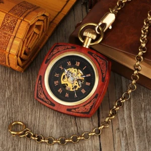 Steampunk pocket watch red wood case with brass chain and skeleton dial, oblique overhead angle on vintage wooden desk