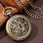 Steampunk pocket watch with bronze hollow carved case and exposed mechanical gears on leather background