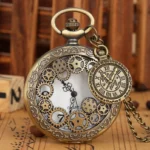 Steampunk hollow pocket watch with bronze tone carved floral borders and exposed gear dial, front close-up view featuring miniature pocket watch charm and included metal chain
