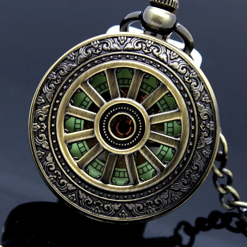 Vintage steampunk pocket watch with carved bronze frame and glowing green skeleton dial, front overhead close-up view