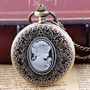 Bronze cameo steampunk pocket watch front view with carved lady profile, displayed on vintage book and newspaper background