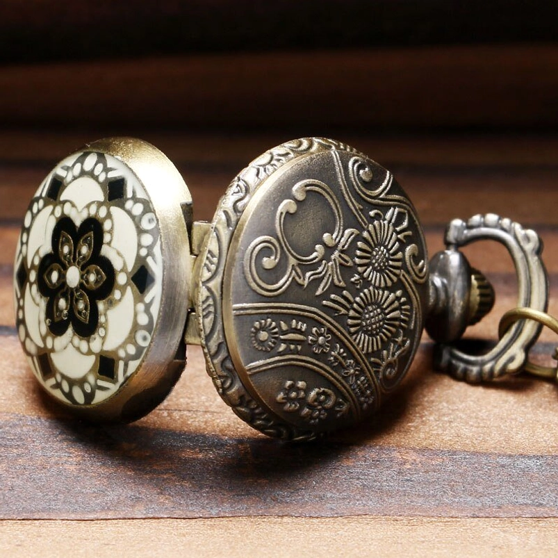 Steampunk pocket watch carved case covers showing detailed floral engraving in vintage bronze