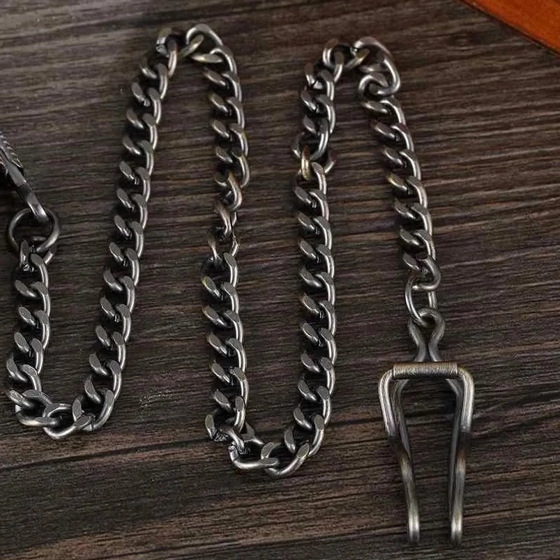 Vintage-style gunmetal black twisted-link pocket watch chain with waistcoat belt clip, flat lay photography on wooden backdrop