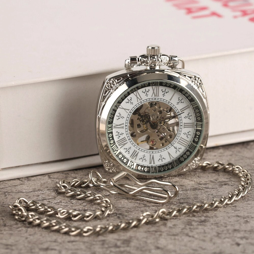 Steampunk pocket watch with silver curb chain included, curved square case with full skeleton dial display on stone tabletop