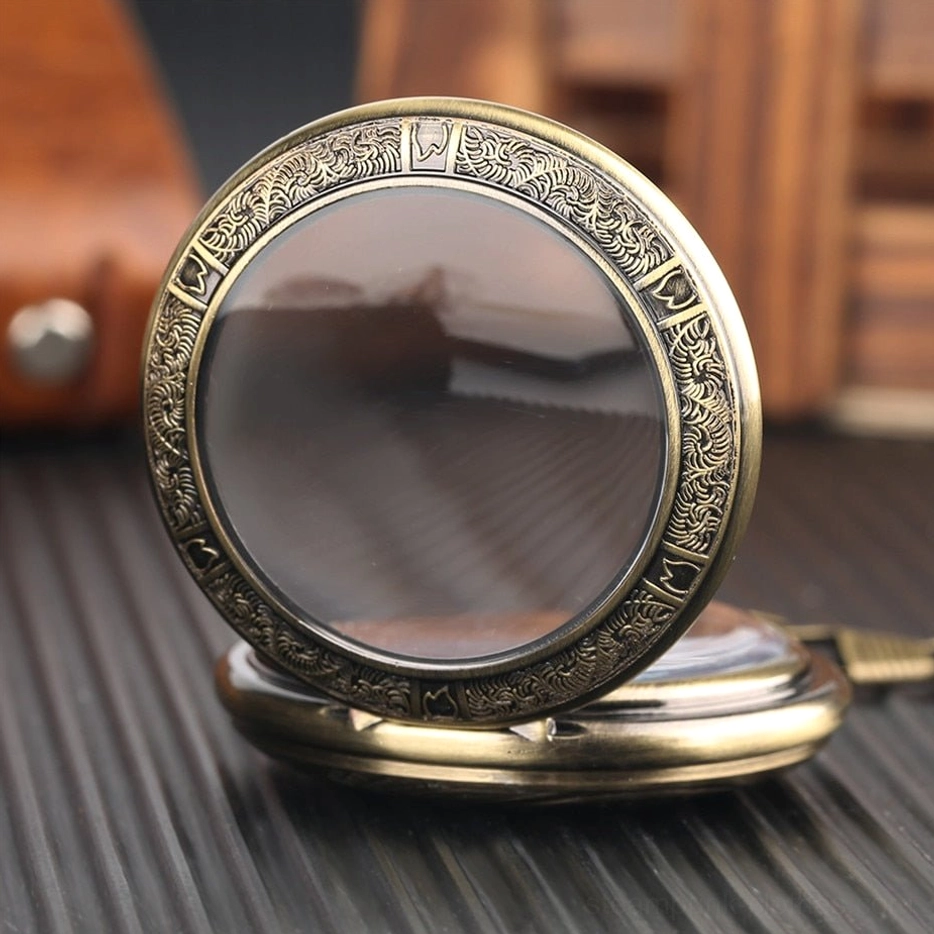 Closed steampunk pocket watch with bronze carved frame and clear protective glass cover on leather and striped tabletop background