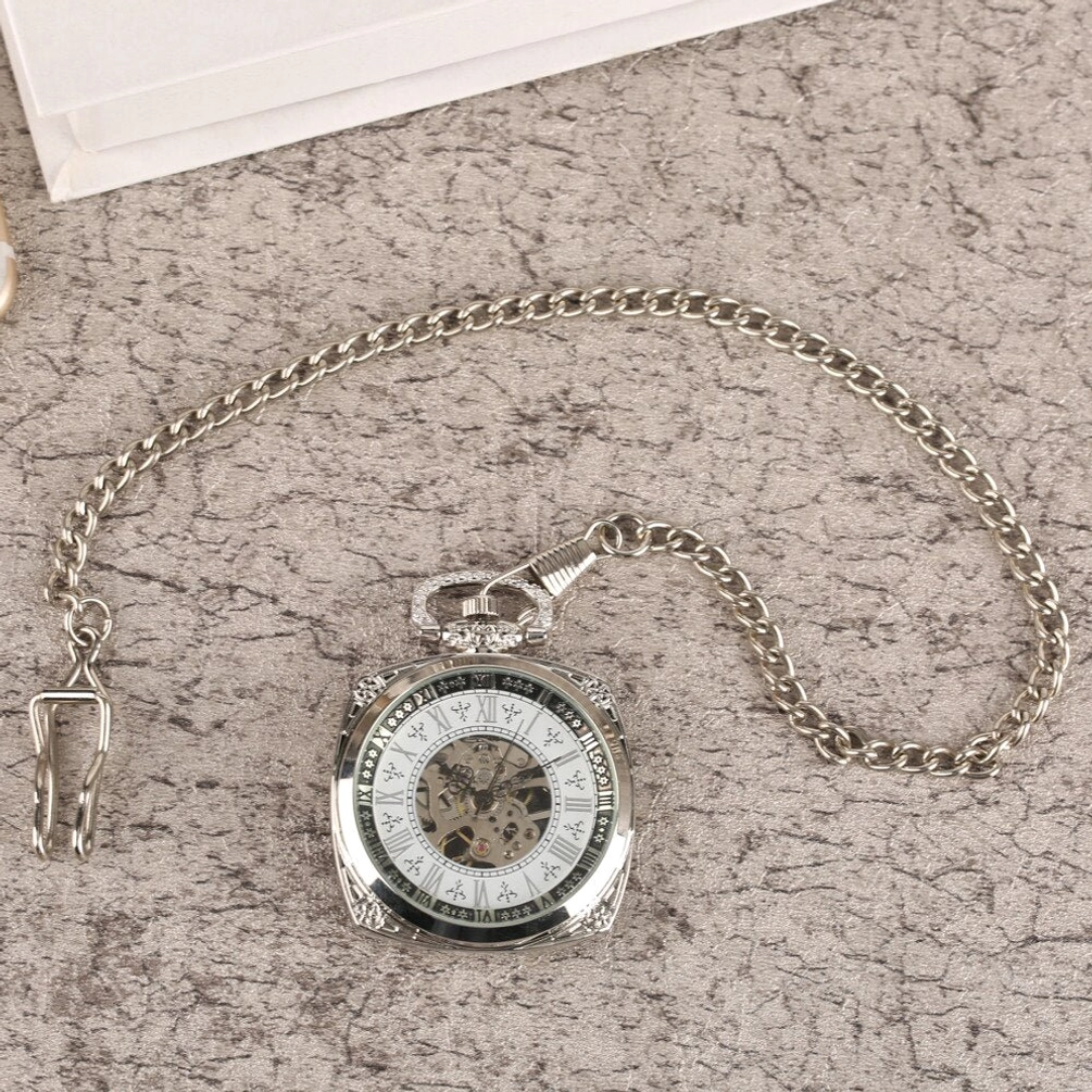 Complete steampunk pocket watch and silver chain set flat lay overhead view with classic skeleton roman dial and polished silver finish