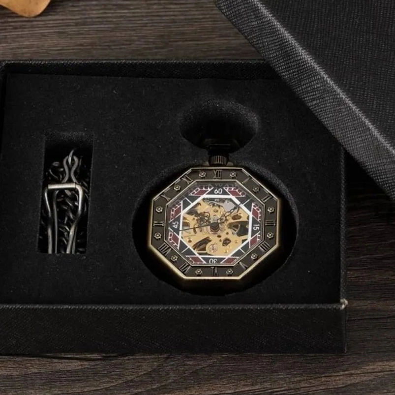 Complete steampunk pocket watch gift set featuring octagonal bronze watch, matching gunmetal chain, and black velvet presentation box on dark wooden surface