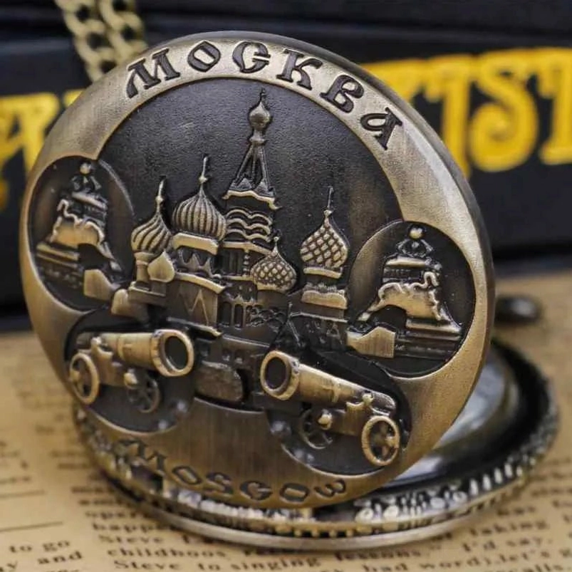 Steampunk pocket watch face cover with three-quarter view showing intricate bronze relief art of Moscow cannons and architecture