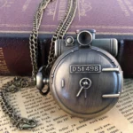 Steampunk D51 locomotive pocket watch front view with antique bronze finish, roman numeral dial, and metal chain on vintage book backdrop