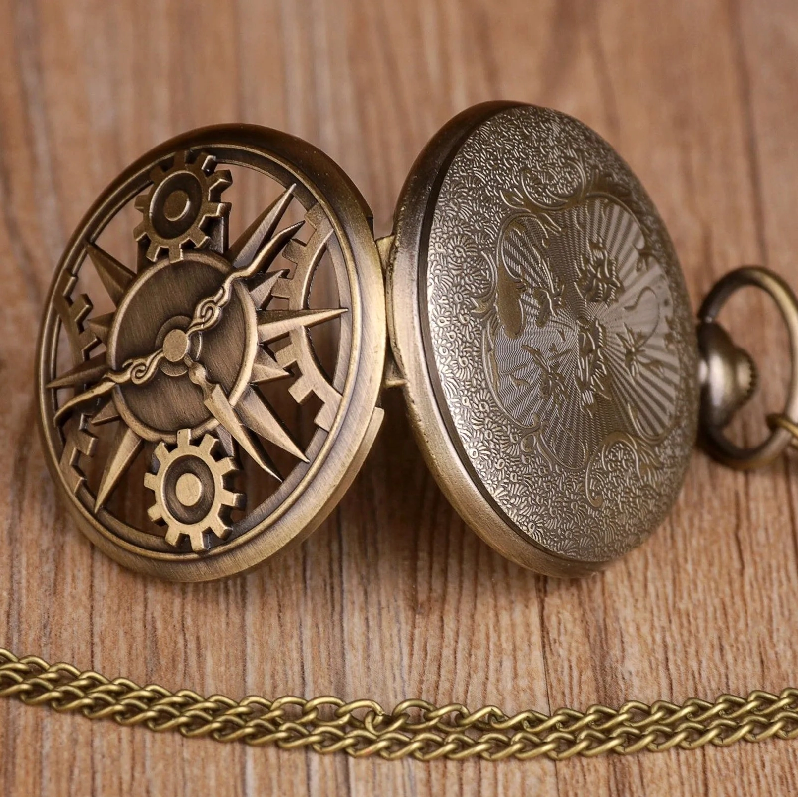 Opened steampunk pocket watch showing both hollowed gear dial front and engraved floral back cover, side overhead perspective revealing dual-design mechanism