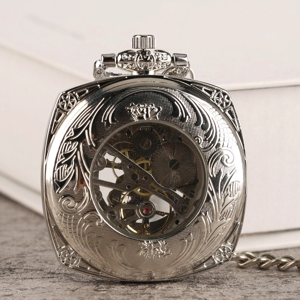 Ornate floral engraved steampunk pocket watch case back view with exposed movement window and crown-shaped top ornament