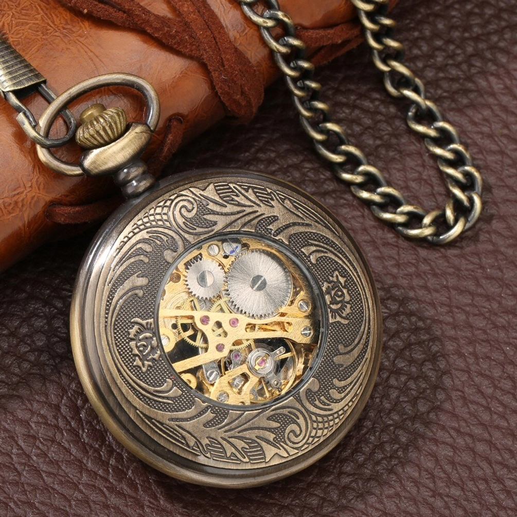Fully engraved bronze steampunk pocket watch with visible mechanical gears and twisted chain