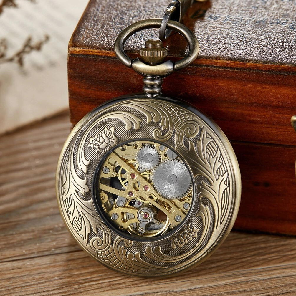Steampunk pocket watch rear view with fully engraved floral bronze metal case, visible golden mechanical gears through skeleton back, flip cover design displayed at angle