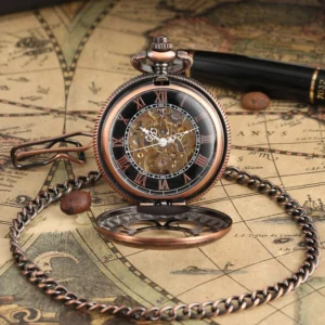 Flip-open steampunk pocket watch with black skeleton dial and visible mechanical movement, attached metal chain on vintage map desk background