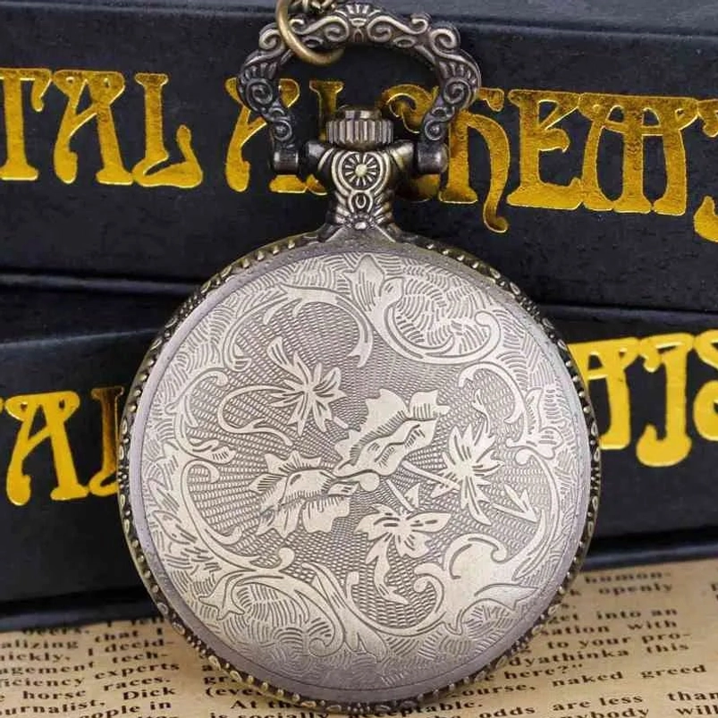 Vintage-style steampunk pocket watch with intricate floral scroll engraving and bronze-silver tone finish