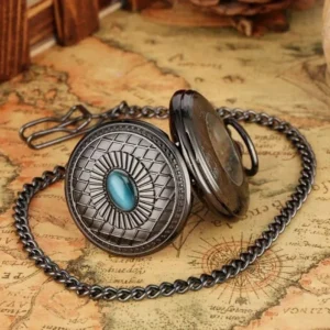 Half-opened mechanical steampunk pocket watch showing dial face, blue stone accent, and attached metal chain with clip on vintage map