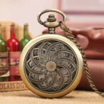 Steampunk hollow flower pocket watch with antique bronze finish and ornate floral carving on retro wine bottle backdrop, showing 3/4 front view