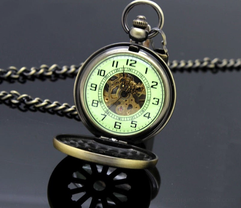 Flipped steampunk pocket watch showing luminous dial, exposed gears, metal curb chain, and cover mechanism