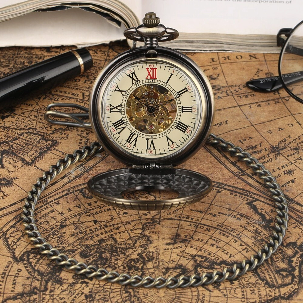 Flip-top steampunk mechanical pocket watch with Roman numeral dial and twisted bronze chain, overhead view on vintage map desktop with fountain pen and glasses