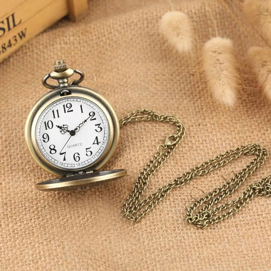 Open steampunk pocket watch with extended chain, half-opened case revealing white dial with black Arabic numerals, bronze metal and chain detail