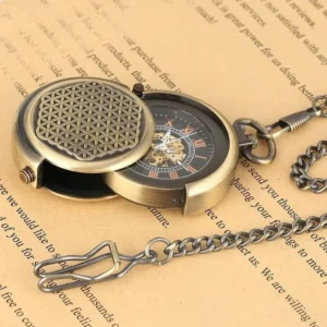 Open steampunk pocket watch showing exposed mechanical skeleton movement and detached metal chain with vintage aesthetic on textured background