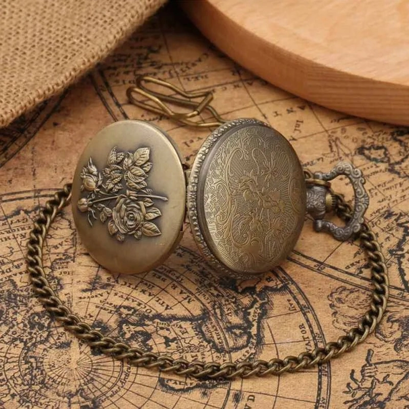 Two vintage steampunk pocket watches with chain, bronze tone metal, one with rose emboss and one with scroll engraving, top-down view on antique map background