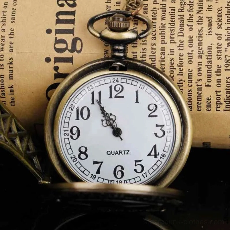 Open quartz pocket watch showing white dial with Arabic numerals and QUARTZ marking, flat lay on vintage newspaper
