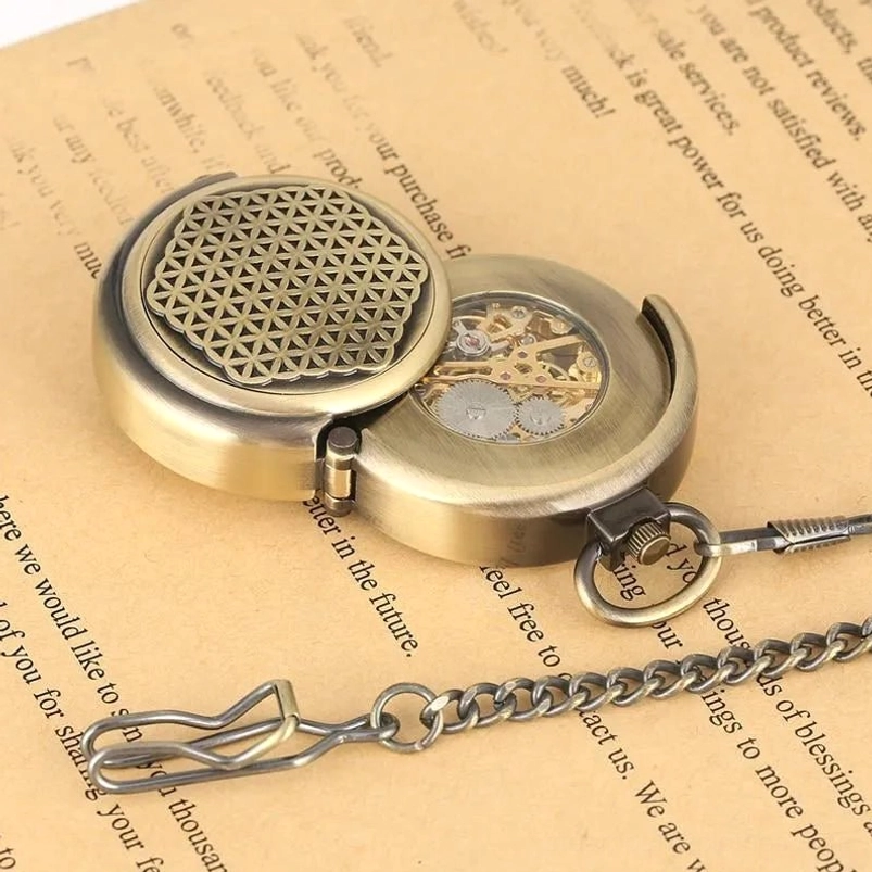 Angled view of mechanical steampunk pocket watch with open case revealing internal skeleton movement and attached metal chain