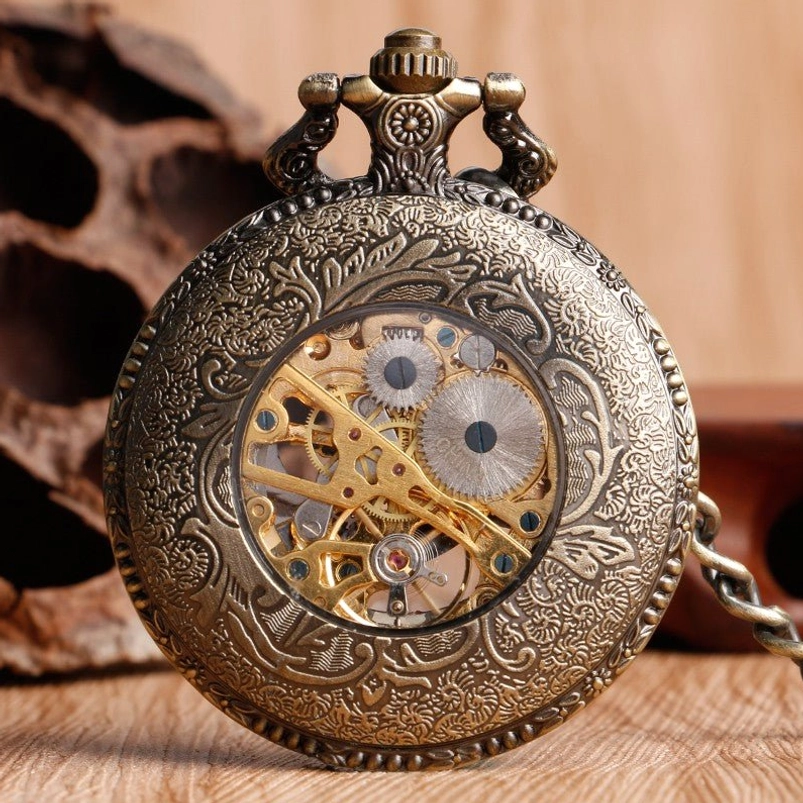 Steampunk skeleton pocket watch front view showing bronze floral engraved case with transparent gear viewing window and mechanical components visible