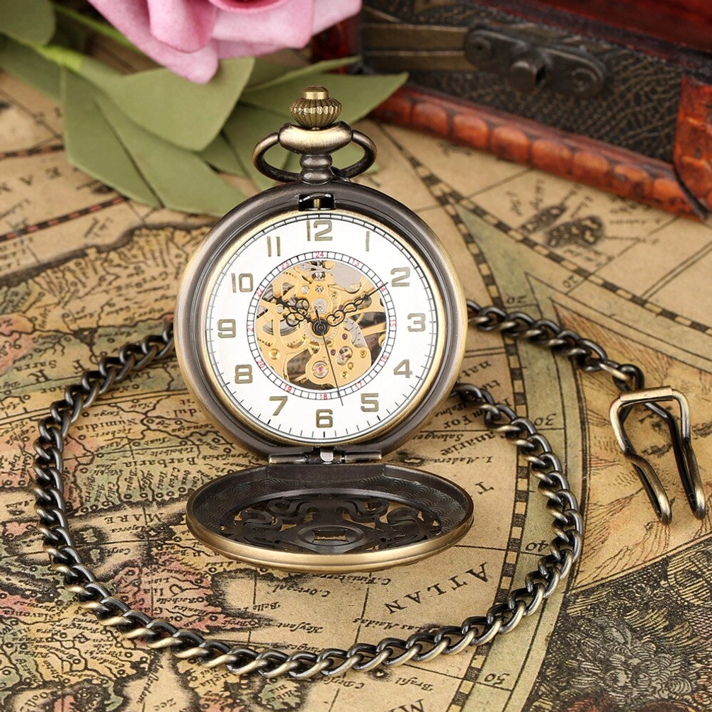 White dial steampunk pocket watch with openable bronze case and Arabic numerals on vintage map backdrop