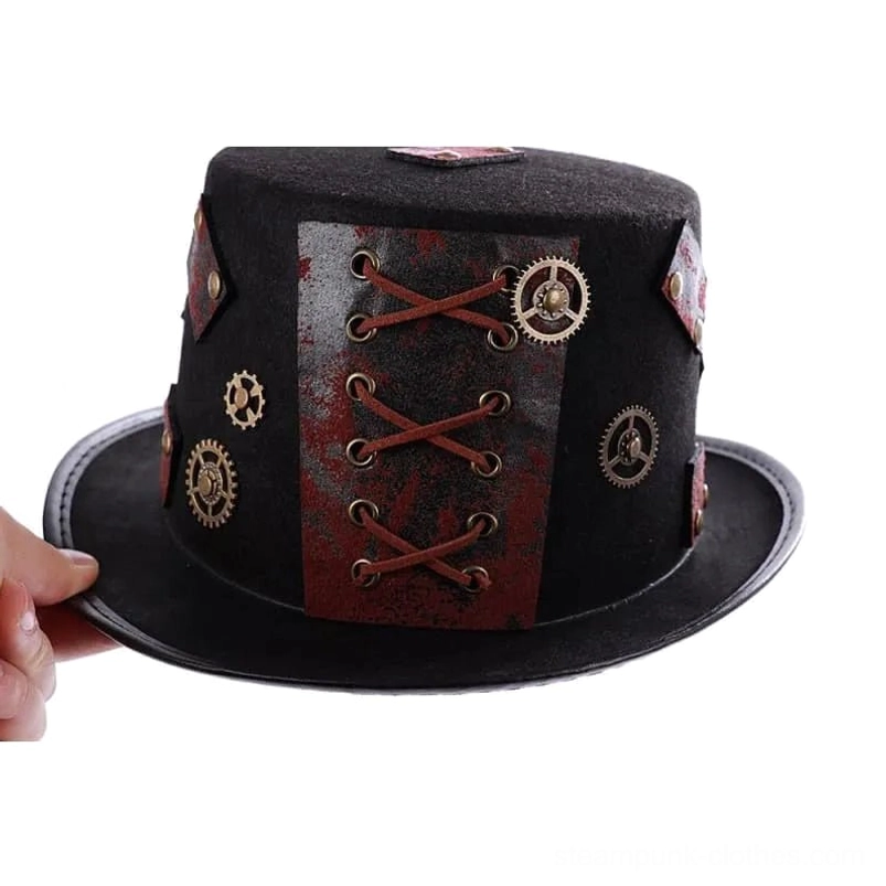 Steampunk top hat held in hand showing red leather weathered accents, lace panel detail, and scale reference