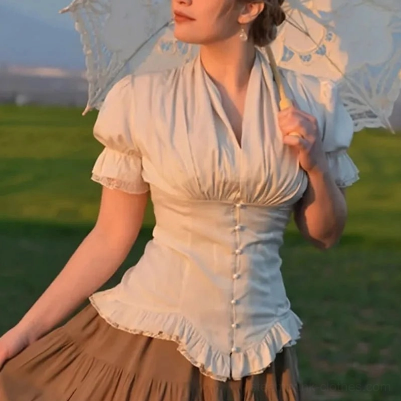 Beige steampunk puff sleeve blouse with vintage Victorian styling, featuring ruched details and ruffled hem, worn by model in outdoor grassland setting