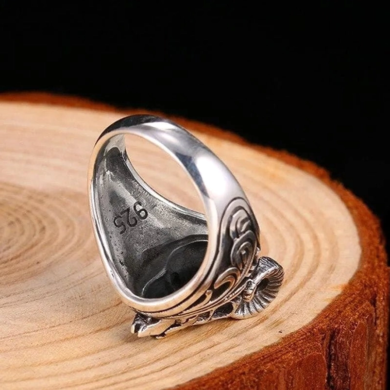 Sterling silver steampunk ring inner band showing 925 hallmark and polished interior with scroll carvings on dark background