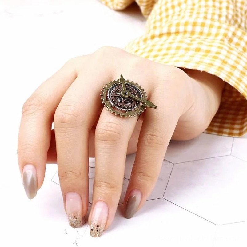 Steampunk gear clock ring worn on female hand middle finger demonstrating comfortable fit and authentic vintage aesthetic in fashion styling
