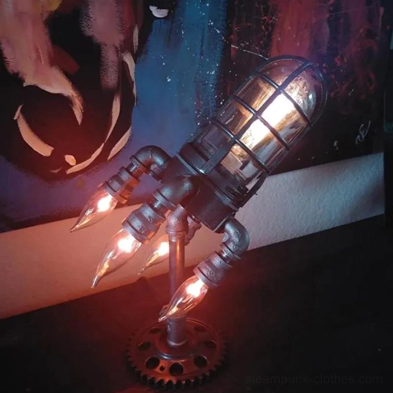 Steampunk rocket desk lamp side perspective with warm glowing Edison filament bulbs and aged black metal finish in dark room setting