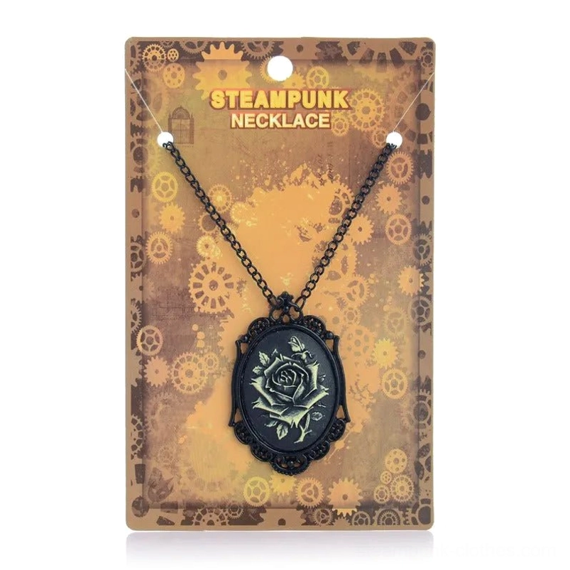 Black filigree steampunk rose cameo necklace with bronze rose motif, displayed on gear-patterned packaging card in retail presentation, showcasing Victorian gothic pendant design