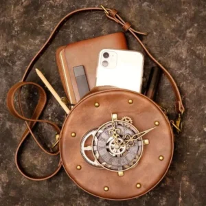 Round steampunk leather crossbody bag flat lay overhead view with brass clock face, personal items, and vintage textured background showcasing interior organization