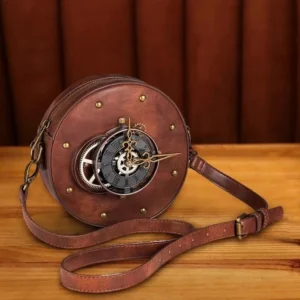 Brown steampunk round leather shoulder bag with adjustable strap, three-quarter front view on wooden table displaying brass hardware and clock face details