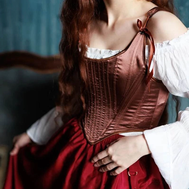 Vintage-inspired brown satin steampunk corset on model in period setting