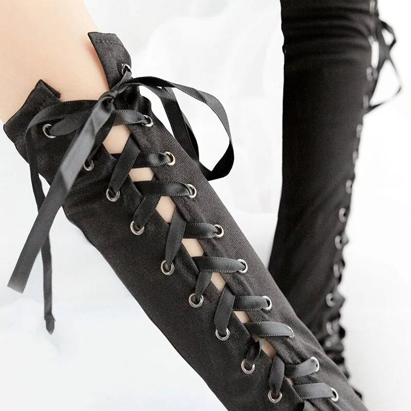 Black steampunk satin lace-up arm sleeves close-up front view displaying ribbon lacing with metal grommets and matte fabric